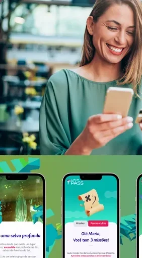 A customer smiling at her phone while using a loyalty app